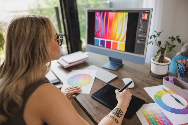 A freelance graphic designer working from home after graphic design training