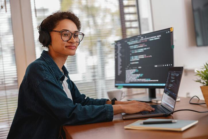 A web developer training graduate working on a computer