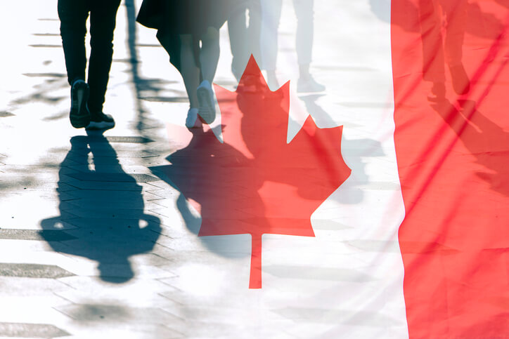 immigration administration assistant helping clients with the Canadian flag as a backdrop