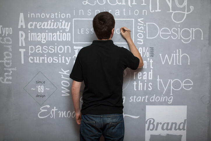  A graphic design training grad working on different fonts on a board