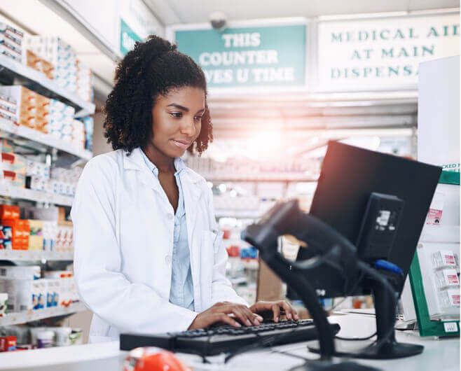 A friendly unit clerk in an office at a clinic after completing her medical office assistant training