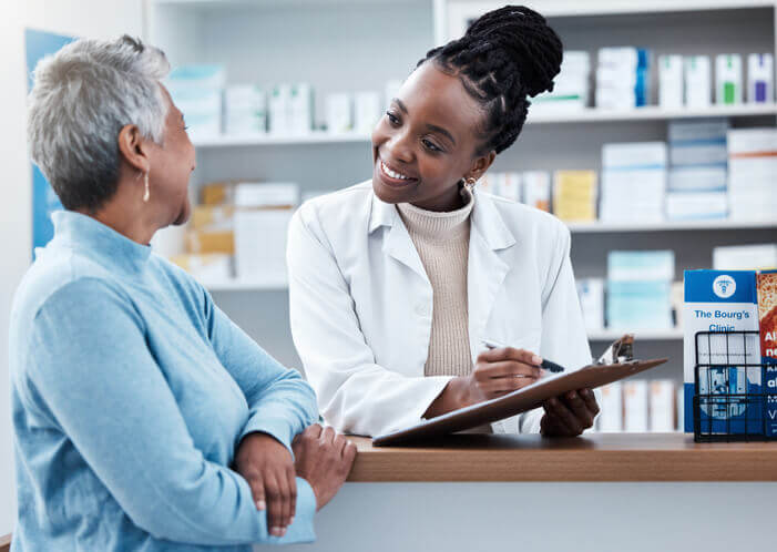 A friendly female unit clerk recording patient health records after completing her medical office assistant training