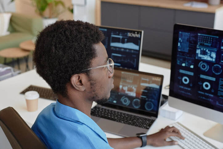 A male web designer working from home after completing his web design training