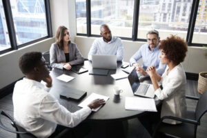 A company of colleagues having a corporate meeting after business management training