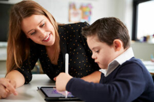 A female Educational Assistant giving personalized attention to a pupil