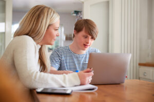 A female educational assistant interacting with a male special education student