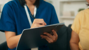 A female Community Service Worker writing a report