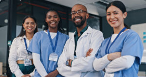 A smiling female health care aide with other members of a healthcare team