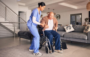 A female health care aide assisting an elderly patient 