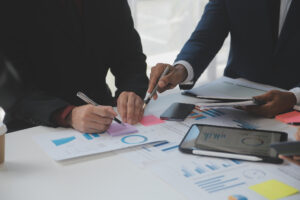 A team conducting market research in an office after completing their business administration training 