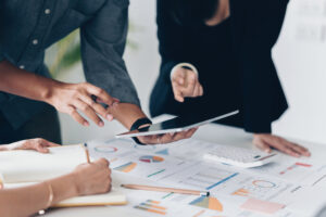 A pair of business professionals planning business strategy in an office after completing their business administration training