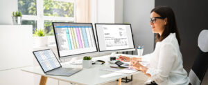  Focused female accounting clerk using accounting software at work after completing her accounting administration training