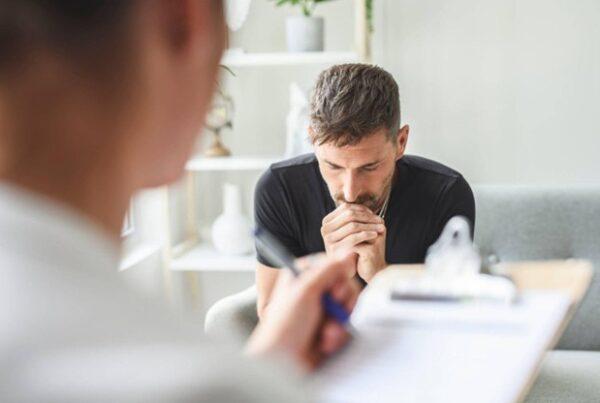 An addiction support worker listening to a client during a counseling session