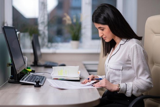 An immigration office assistant preparing visa documentation