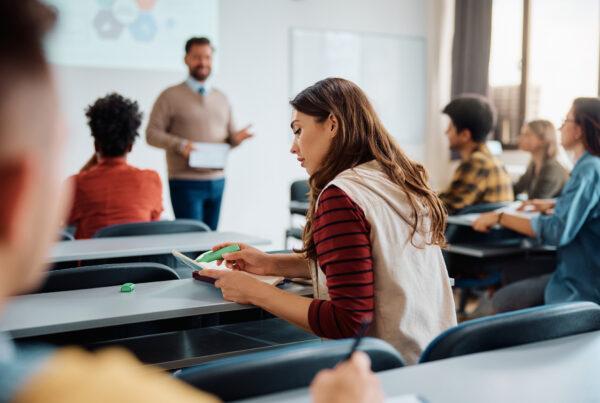 A health care aide student learning self-care tips in class
