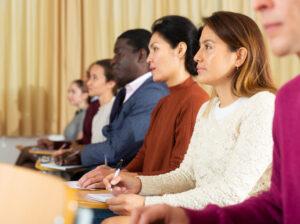 A group of adult learners attending a career college orientation session
