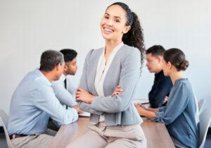 A graduate of an administrative assistant program coordinating a team meeting