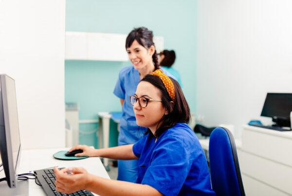 A student in medical office assistant training learning to manage electronic health records