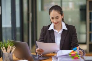 A legal administrative assistant reviewing documents in a law office