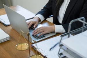A student practicing typing and document preparation during legal assistant training