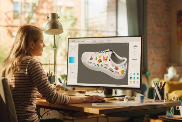 A graphic designer creating visual concepts using Adobe Illustrator