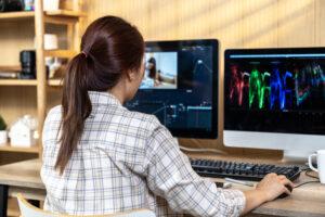 A student editing video and motion graphics with Adobe After Effects