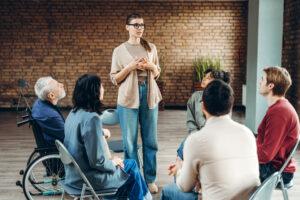 A group therapy session led by a trained community service worker