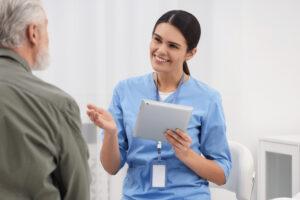 A student practicing patient communication during health care aide training in Alberta