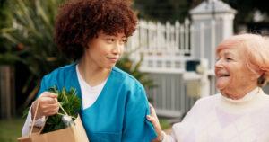 A community service worker training graduate helping a client in Alberta