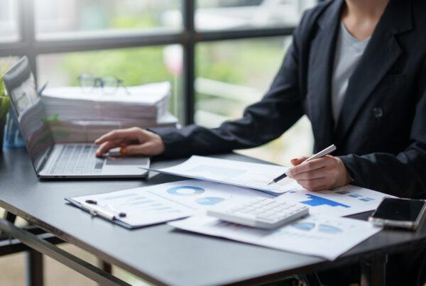 An accounting administrator analyzing financial reports for business decisions