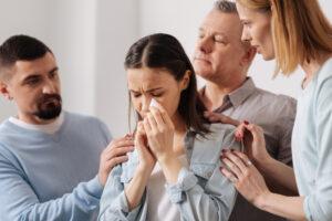 A team of health care aide training graduates offering emotional support to a family after receiving difficult news 
