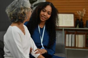 A health care aide training graduate providing guidance and reassurance in a clinical setting
