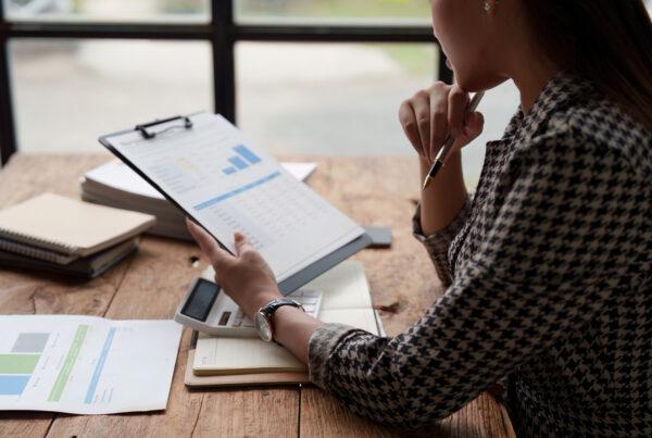 An accounting administrator reviewing financial reports at month-end