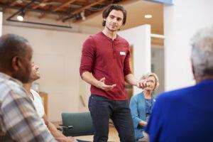 Community service worker advocating for client rights during a support meeting