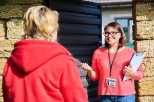 Community service worker assisting a client with accessing housing and social services