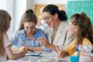 A student using a checklist and visual aids with support from an educational assistant