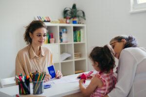 A school support team meeting with the educational assistant, teacher, and specialist, discussing student progress