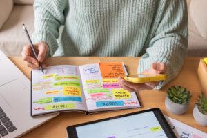 Career college student using a planner to balance work and school schedule