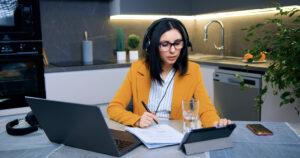 Working professional attending an online class while managing job responsibilities