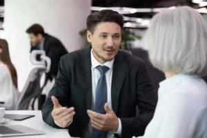 Business manager speaking with an employee to address workplace concerns professionally.