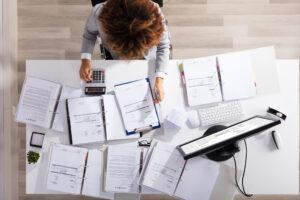 Accounting assistant preparing spreadsheets and invoices for audit review